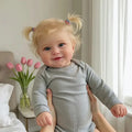 A 20-inch (50 cm) full vinyl reborn baby girl doll named Maddie with rooted blonde hair.