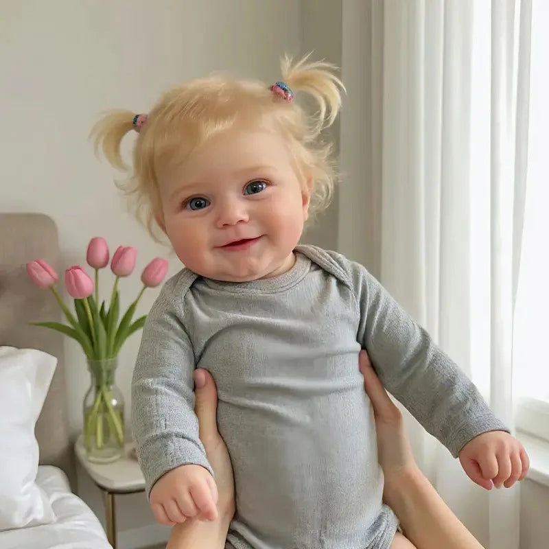 A 20-inch (50 cm) full vinyl reborn baby girl doll named Maddie with rooted blonde hair.