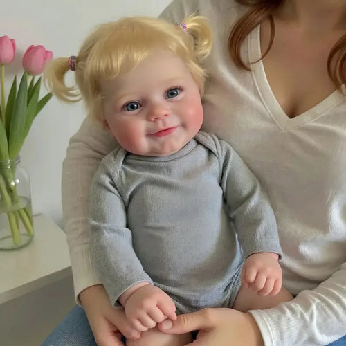 A 20-inch (50 cm) full vinyl reborn baby girl doll named Maddie with rooted blonde hair.